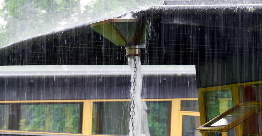 Starker Regen – Regenkette an einem Vordach.